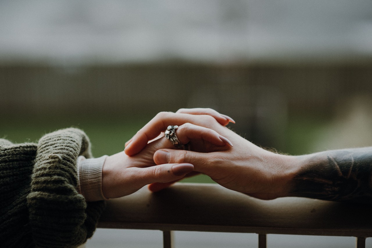 couple with fashion jewelry holding hands