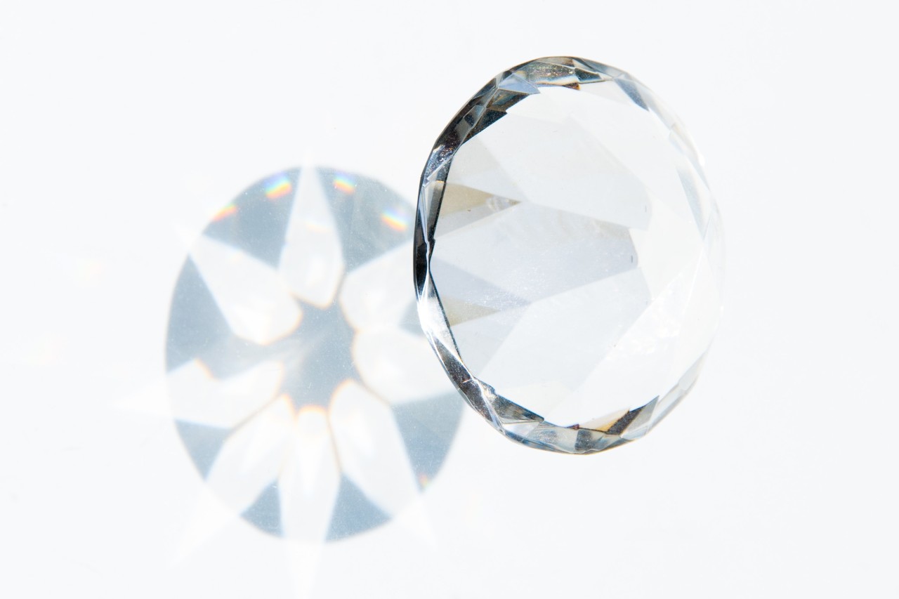 Round cut diamond emitting its signature white fire