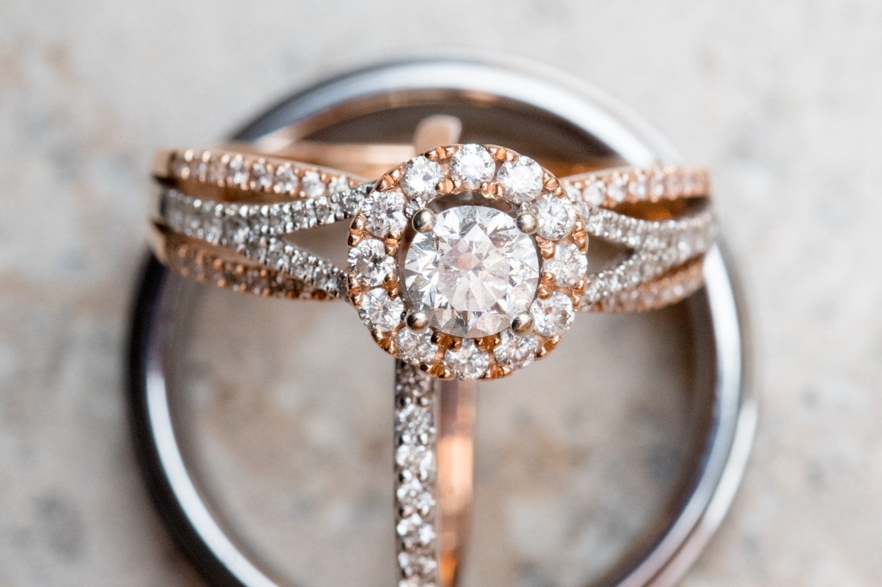 Engagement ring with a prominent center stone surrounded by a dazzling diamond halo