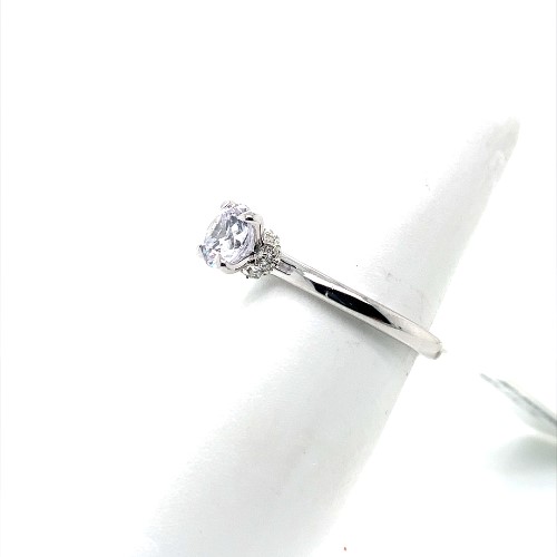 A white gold hidden halo diamond engagement ring.
