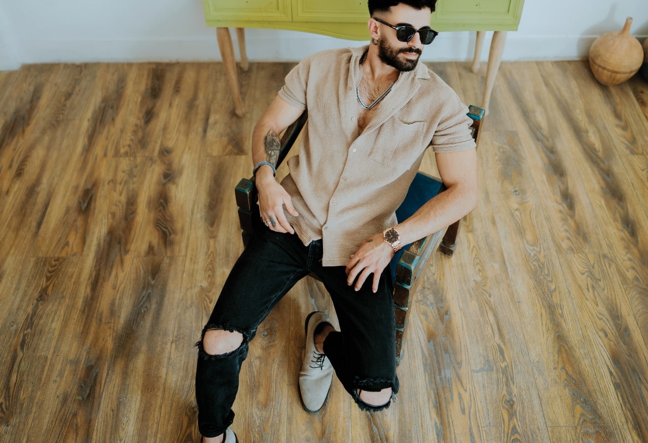 Guy Relaxing on a Chair Wearing a Watch