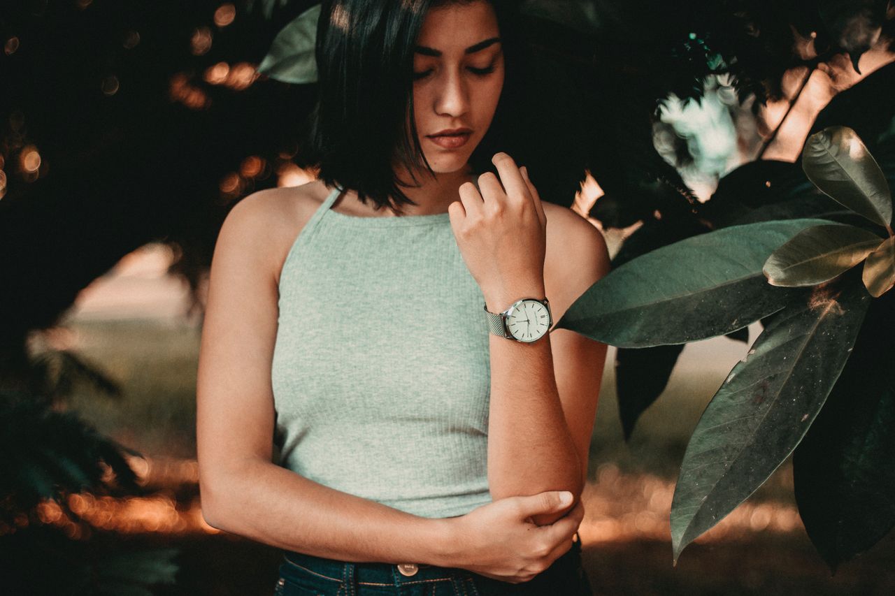 Young woman proudly inspects her timepiece