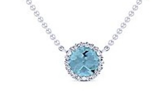 a silver pendant necklace with a round cut blue topaz center stone