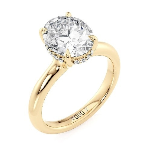 A stupendous hidden halo oval cut gold engagement ring.