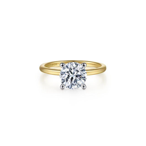 A yellow gold Gabriel & Co. diamond solitaire engagement ring.