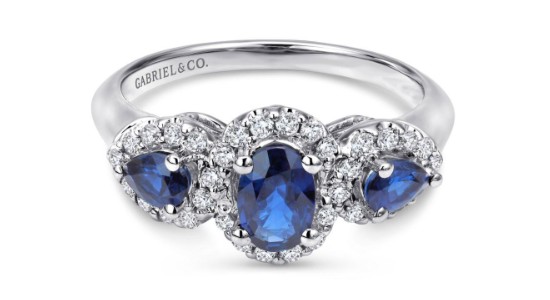 a white gold fashion ring featuring three sapphires surrounded by diamonds