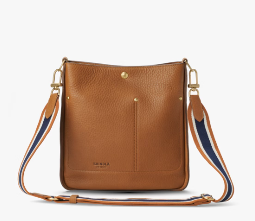 A pocket crossbody bag in a tan color