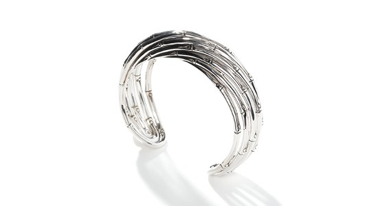 a silver cuff bracelet with bamboo-like details and texture.