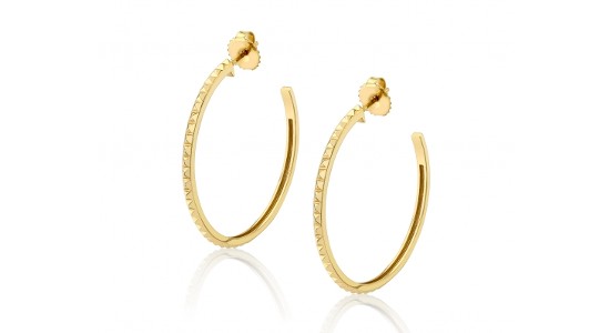 a yellow gold pair of hoops with a unique oval shape