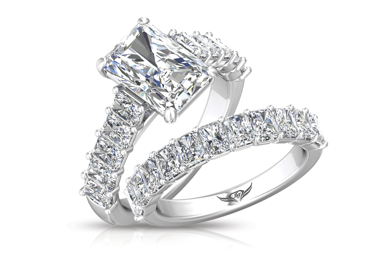 An emerald cut white gold side stone engagement ring with emerald cut diamonds along the band and a matching emerald cut diamond wedding band by Martin Flyer. An emerald cut white gold side stone engagement ring with emerald cut diamonds along the band and a matching emerald cut diamond wedding band by Martin Flyer.