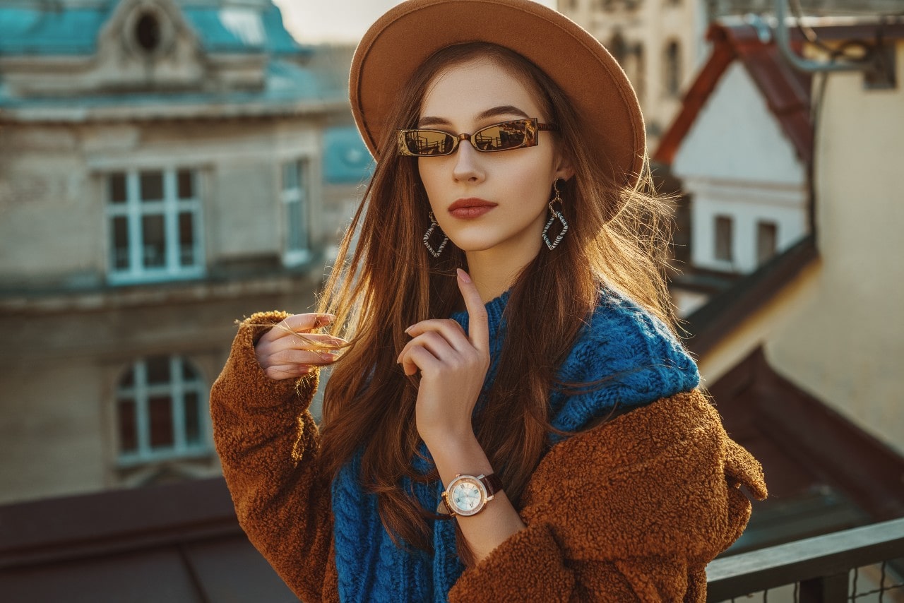 A woman wearing sunglasses, hat and earrings A woman wearing sunglasses, hat and earrings